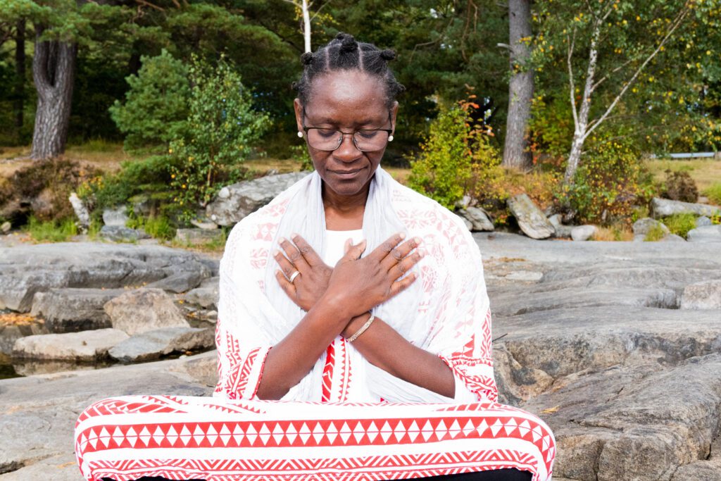 Jacqueline Vanderpuye Sitting by a the forest meditating